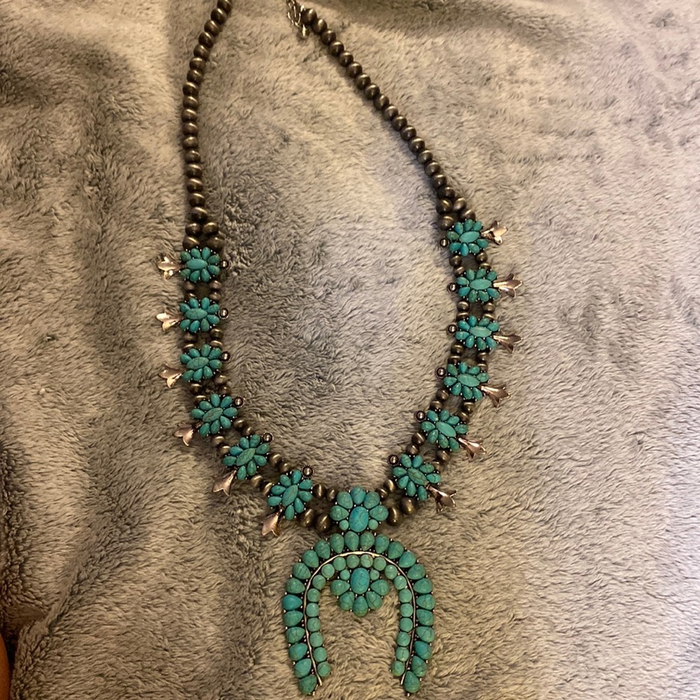 Faux turquoise squash blossom.